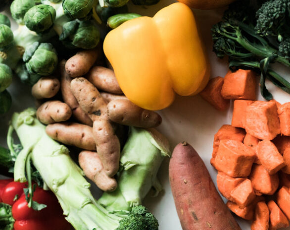 A collection of fall veggies including potato, bell pepper, and broccoli.