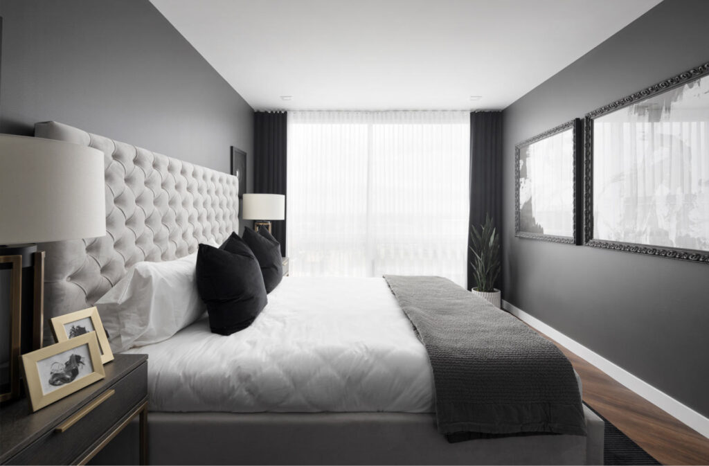 a master bedroom by truman homes with a dark and light grey colour scheme