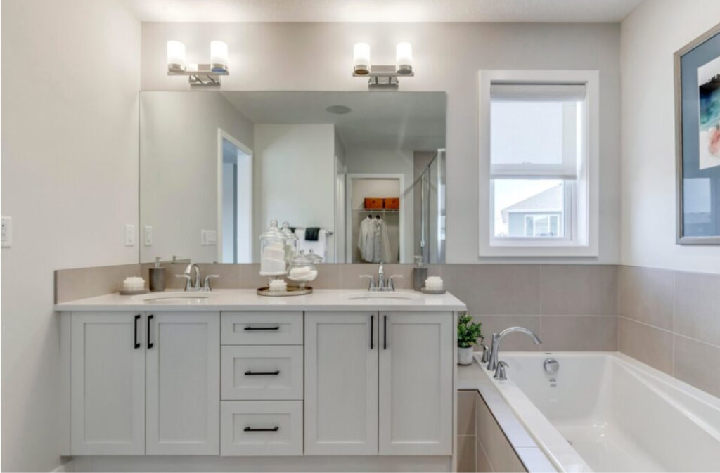 bathroom in one of westcreek homes home models featuring two sinks and a large soaker tub